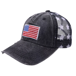 Close-up of vintage American flag patch and distressed denim on mesh ponytail baseball cap