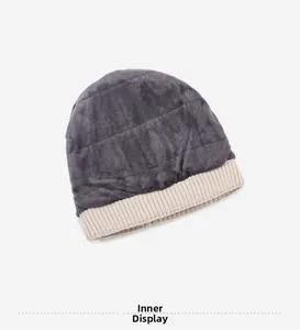 Detail view of winter knitted hat featuring thick grey plush lining and ribbed beige edge