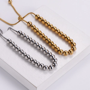 Adjustable minimalist stainless steel bead bracelet in polished gold and silver finishes
