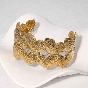 Golden stainless steel butterfly cuff bracelet with detailed 18k gold relief textures
