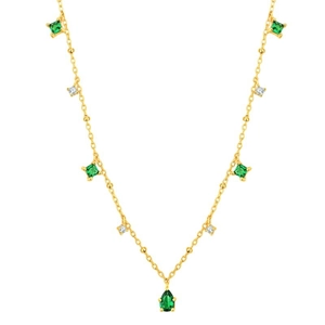 Detailed shot of emerald green teardrop pendant on golden chain with zircon accents
