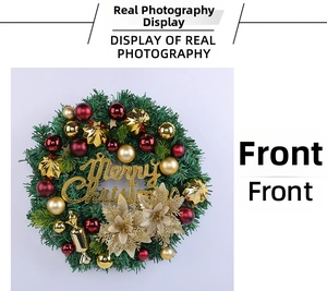 Front view detail of a Christmas wreath with red and gold baubles and Merry Christmas sign