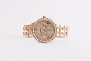Detailed macro view of rose gold quartz watch with diamond accents and Geneva dial