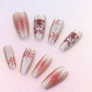 Close-up of cat-eye press-on nails with cartoon cat graphics and fireworks design