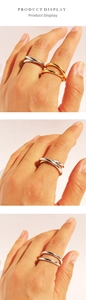 Detailed views of gold and silver crossover layered rings showing different finger placements