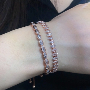 Detail of rose gold tennis bracelets with marquise zircons worn on a female wrist