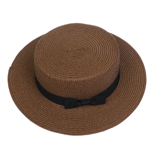 Top view of dark brown straw flat top hat with black ribbon bow and textured weave