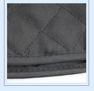 Close-up of heat resistant kitchen glove with black quilted diamond pattern stitching