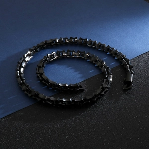 Detail of a sleek black geometric stainless steel chain link bracelet in hip hop style
