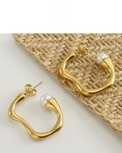 Detailed macro view of 18K gold plated irregular geometric earrings with white pearls