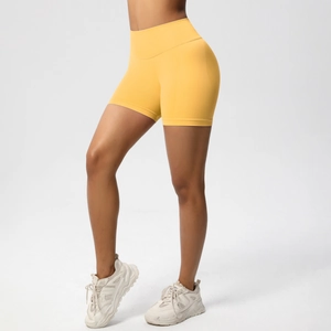 Detailed side view of yellow seamless high-waist yoga shorts with push-up effect