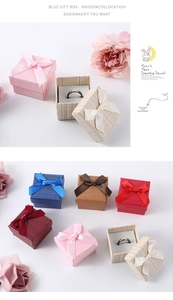 Detailed view of square jewelry gift boxes with satin bows and sponge interior padding