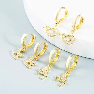 Detailed view of gold alloy hoop earrings with horse, bird, and swan motifs with diamonds