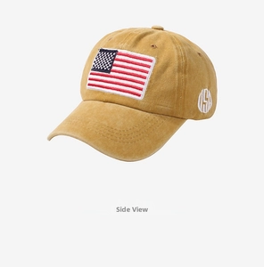 Detail of yellow cotton baseball cap with American flag and USA side embroidery