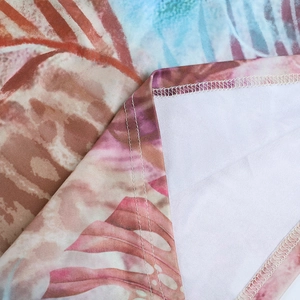 Detail shot of tropical print fabric showing high-quality stitching and seam finish
