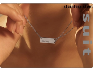 Detail of silver rectangular pendant necklace on neck made of durable stainless steel