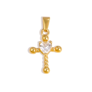 Macro detail of gold-plated cross pendant featuring a heart-shaped zircon center stone