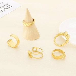 5-piece gold stainless steel ring set featuring twisted, smooth, and open line designs