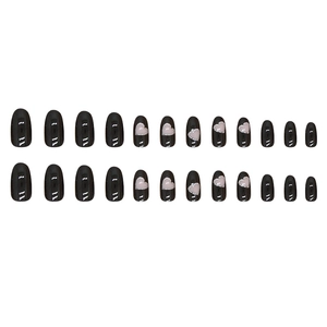 Short oval black fake nails with silver glitter hollow heart designs and glossy finish