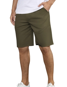 Detail view of olive green loose-fitting men's sports shorts with quick-dry fabric texture