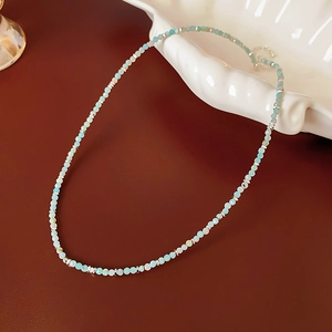 Detail of Amazonite beaded necklace with silver spacers on a white shell tray