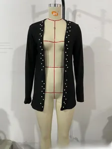 Detail of black ribbed knit cardigan featuring decorative white pearls along the placket