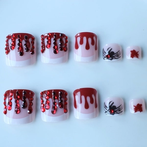 Halloween style press-on toe nails with dark red rhinestones and blood drip design