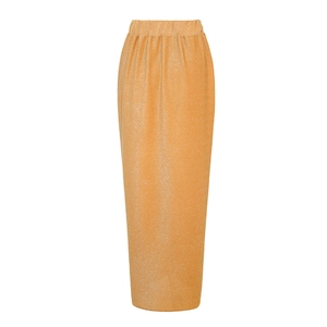 Close-up of golden metallic pleated fabric texture on a long skirt with elastic waist