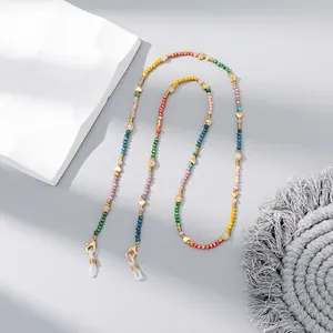 Detail of colorful crystal beaded eyeglass chain with gold heart charms and lobster clasps