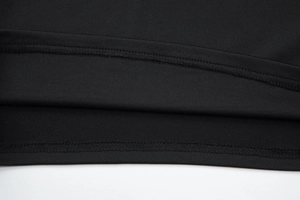 Detailed close-up showing precision double-needle stitching on the black top hem