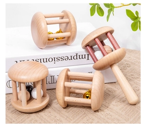 Detail of a 4-piece Montessori wooden baby rattle set on a soft knit background
