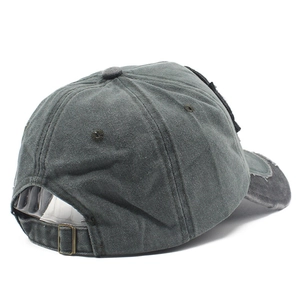 Detail showing the adjustable metal buckle and vintage washed texture on dark grey baseball cap