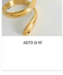 Detailed view of the gold snake wrap ring featuring textured serpent head craftsmanship