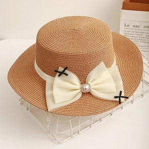 Flat top straw sun hat with mesh bow, pearl accents and wide brim for summer beach vacation