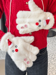 Close-up of white plush snowman gloves with festive 3D red hat and button details