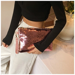 Detailed close-up of pink sequined mini clutch bag with metallic zipper and wrist strap