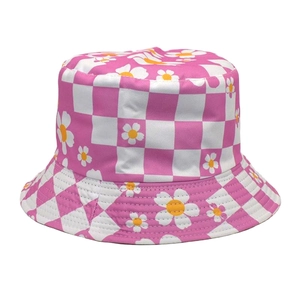 Detail of pink checkerboard sun hat with white daisy prints and fine twill stitching