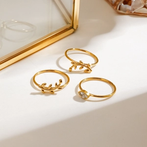 Three-piece set of gold stainless steel stackable rings with olive leaf and marquise zircon
