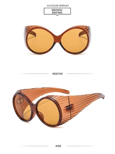 Detail view of brown Y2K oversized round sunglasses with striped texture and side profile