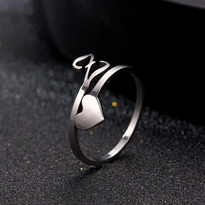 Macro side view of silver adjustable heart ring in stainless steel with polished finish