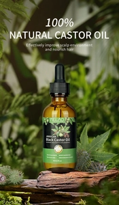Macro shot of 60ml Jamaican Black Castor Oil bottle on wood base with herbal background