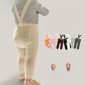 Close-up of baby high-waisted ribbed knit leggings with adjustable suspenders in cream color