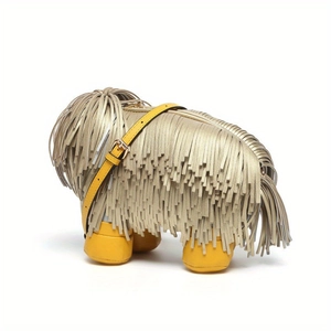 Detailed close-up of a creative dog-shaped handbag featuring golden fringe and yellow faux leather