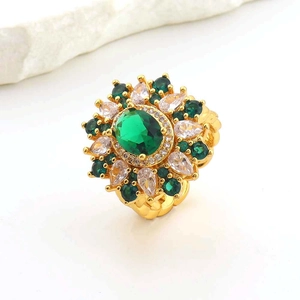 Detailed close-up of a vintage gold open ring with green oval stone and floral accents
