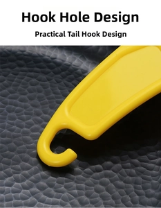 Detail of a bright yellow silicone kitchen scraper featuring a practical hanging hole design