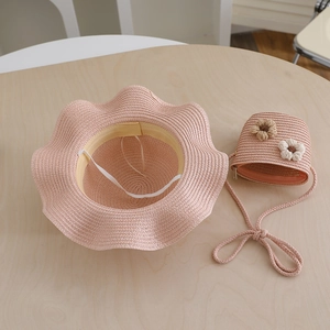 Detailed view of pink woven straw sun hat and matching flower crossbody bag set