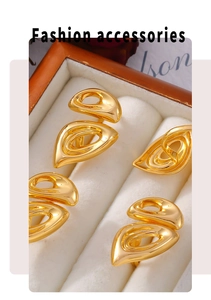 Detailed view of five gold leaf-shaped earrings displayed in a premium jewelry box
