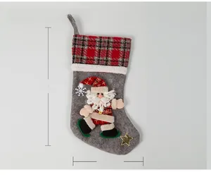 Detail of Christmas stocking featuring 3D Santa doll and red plaid cuff with dimensions