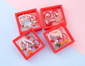 Detail of Christmas kids jewelry gift set with reindeer, snowflake charms and pearl bracelets