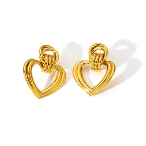 Detail of gold-plated heart drop earrings showing triple-layered hollow design texture